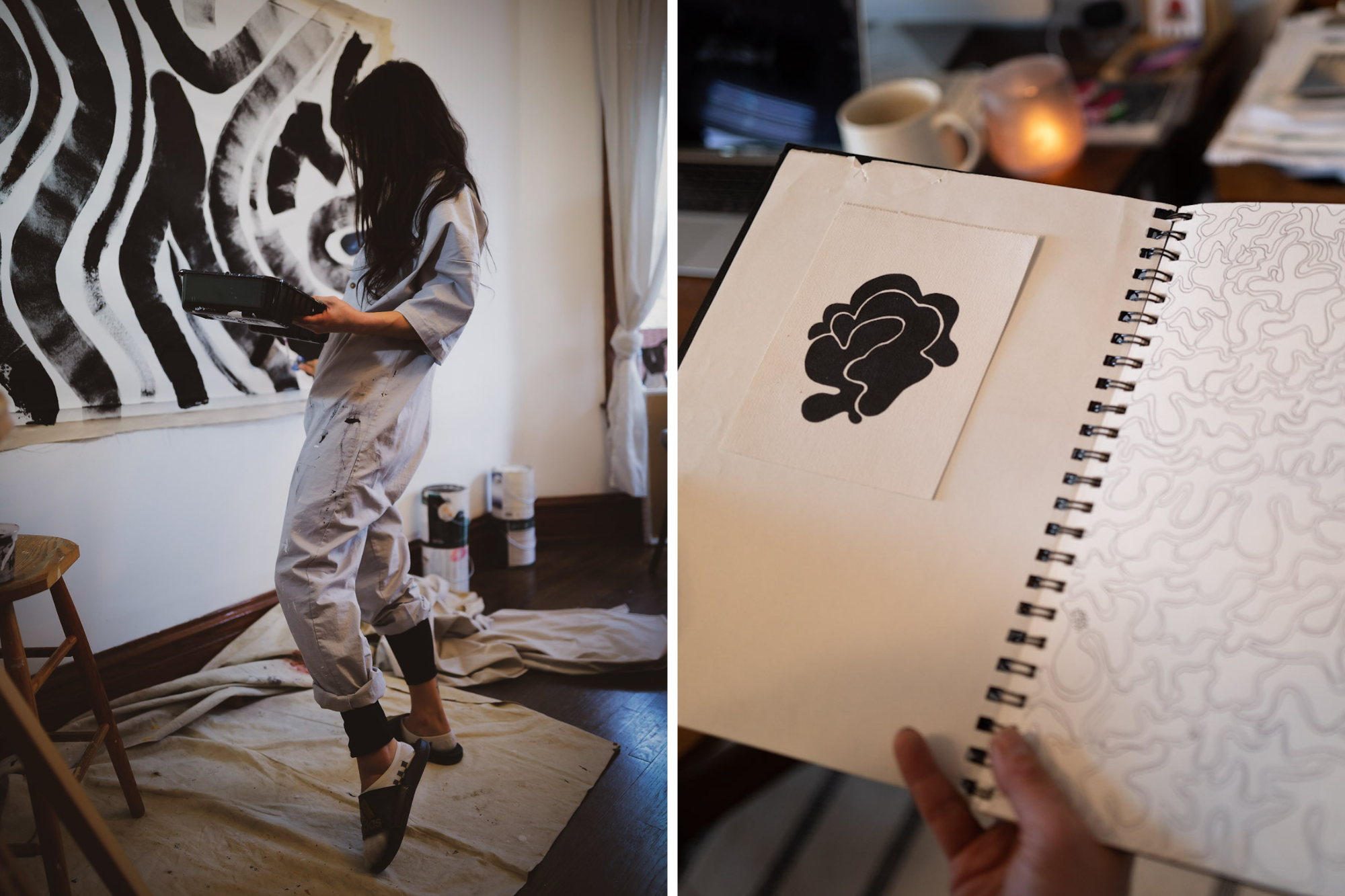 Woman in white overalls paint black and white wall art and follows linework design in art journal